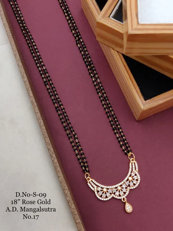 https://d1311wbk6unapo.cloudfront.net/NushopCatalogue/tr:f-webp,w-600,fo-auto/D-NO-S-09 ROSE GOLD AD 18 FANCY MANGALSUTRA_1684936624672_24ek3qz2gqteuny.jpg__Ketmera